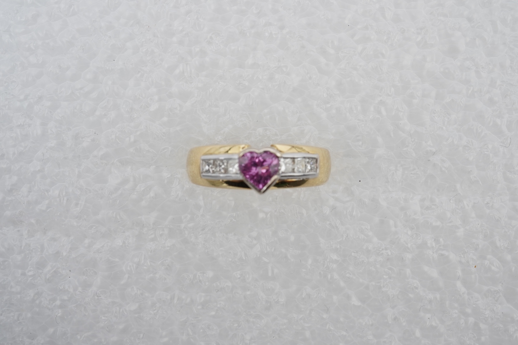 A pink sapphire and diamond ring